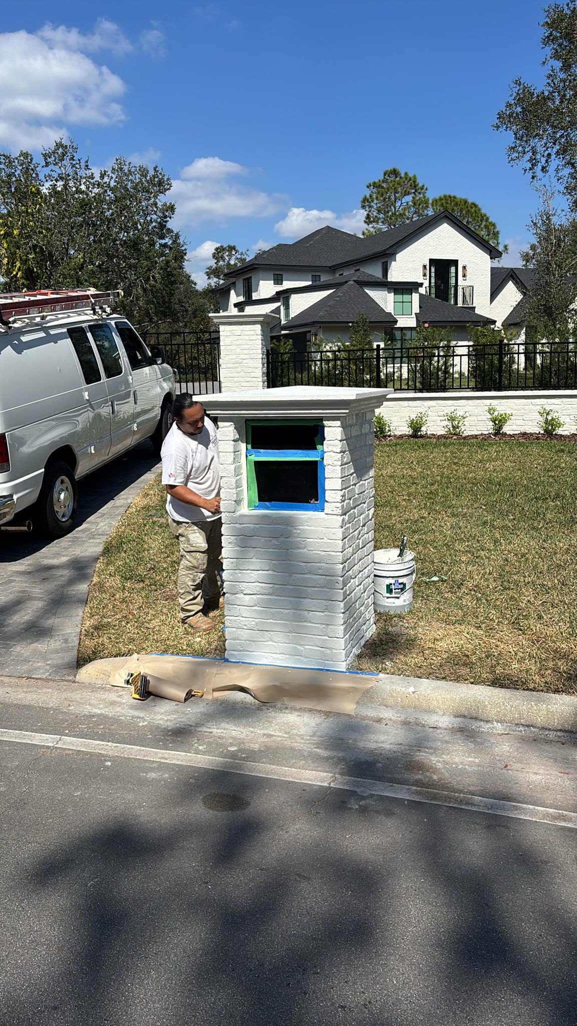 Brick mailbox pillar being painted