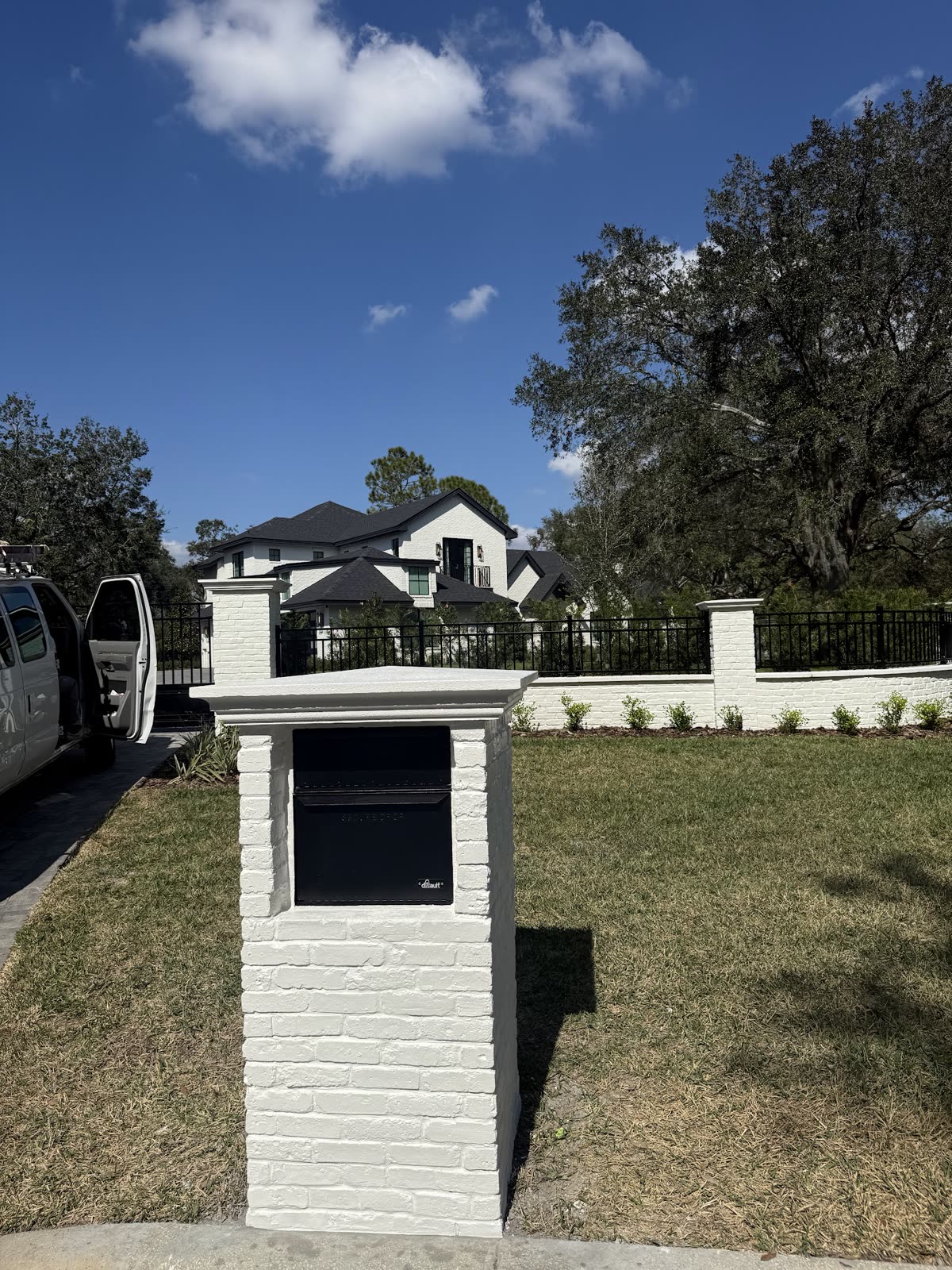 Finished white brick mailbox pillar
