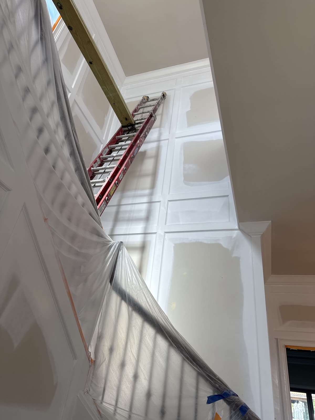 Stairwell wainscoting being painted